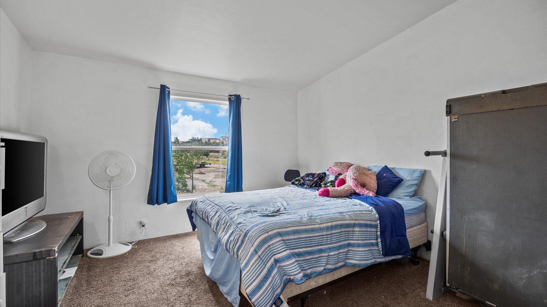 110 Blair Road Whitewater, CO 81527 - Photo 21 of 32 a bedroom with a bed and a window