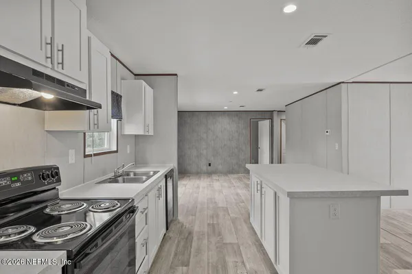 a kitchen that has a sink and a stove