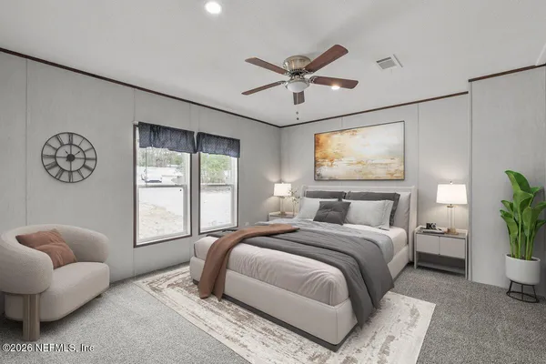 a bedroom with a bed couch and window