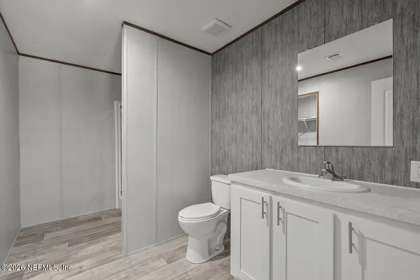 a bathroom with a toilet a sink and a mirror