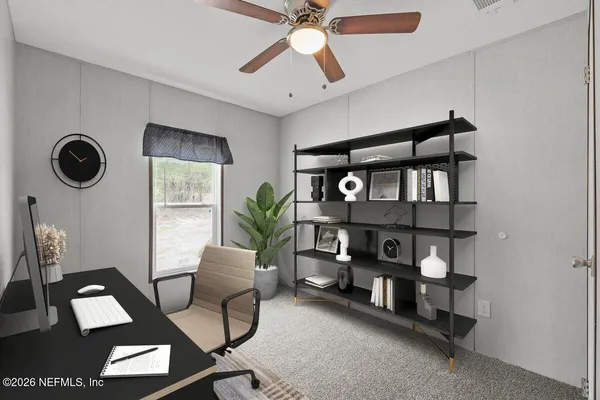 a view of a workspace with furniture and a potted plant
