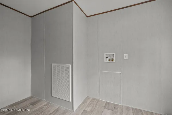 a view of dirt yard with large trees