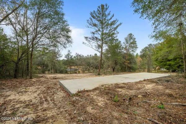 a view of a yard with furniture and wooden fence