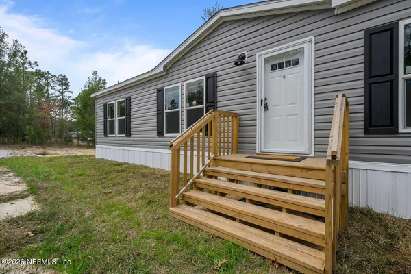 a view of a house with a backyard