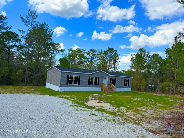 a view of a city street with a yard
