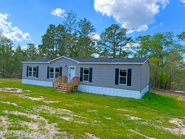 an aerial view of a house with a yard