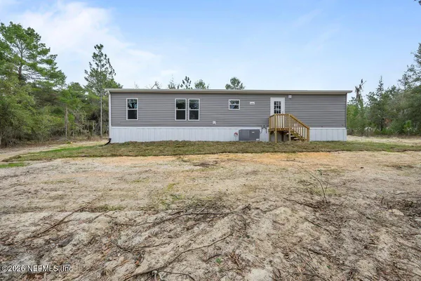 an aerial view of residential building with outdoor space and trees