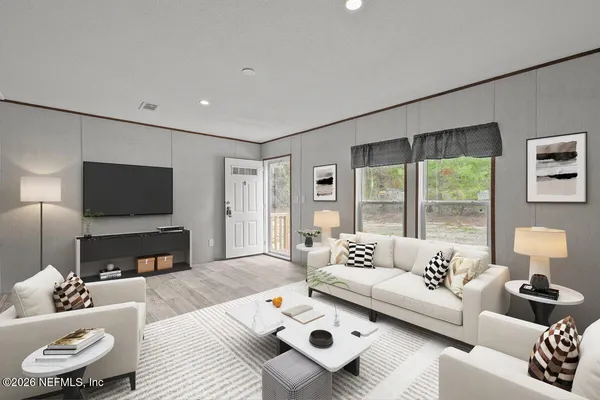 a living room with furniture and a flat screen tv