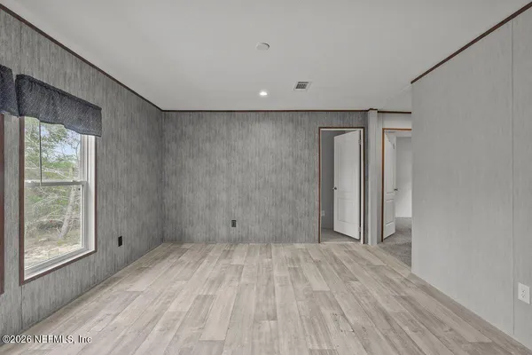 a view of a room with wooden floor and window