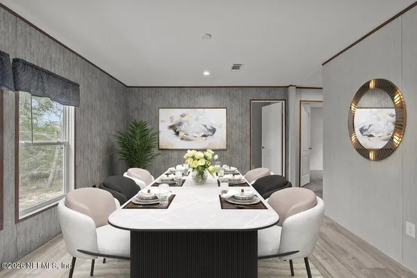 a view of a dining room with furniture window and wooden floor