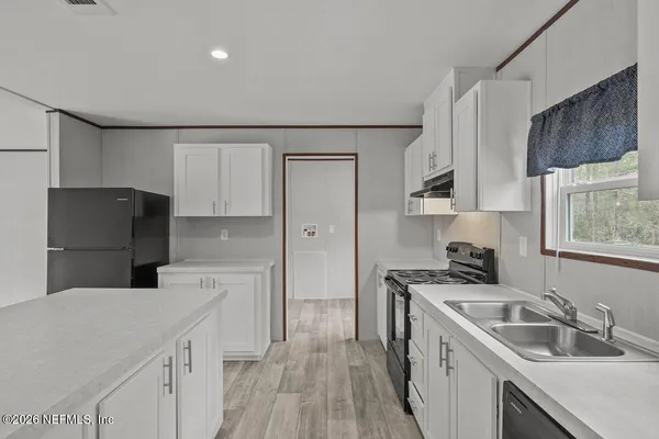a kitchen with a sink stove and refrigerator
