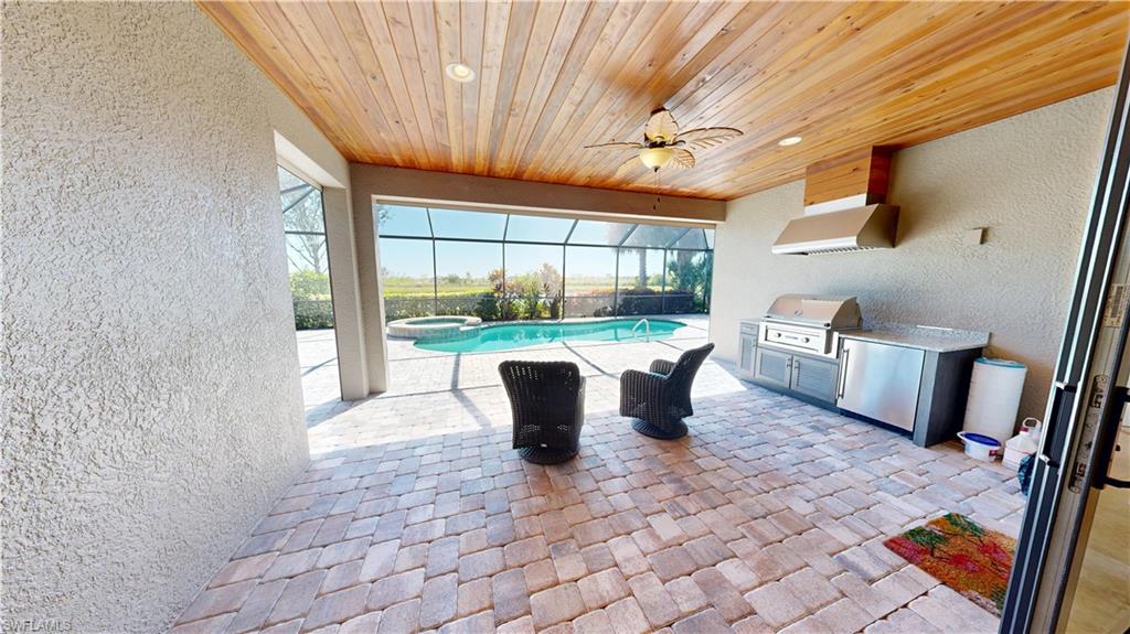 6354 Achievement Avenue Ave Maria, FL 34142 - Photo 18 of 50 a view of a dining room with furniture wooden floor and a chandelier