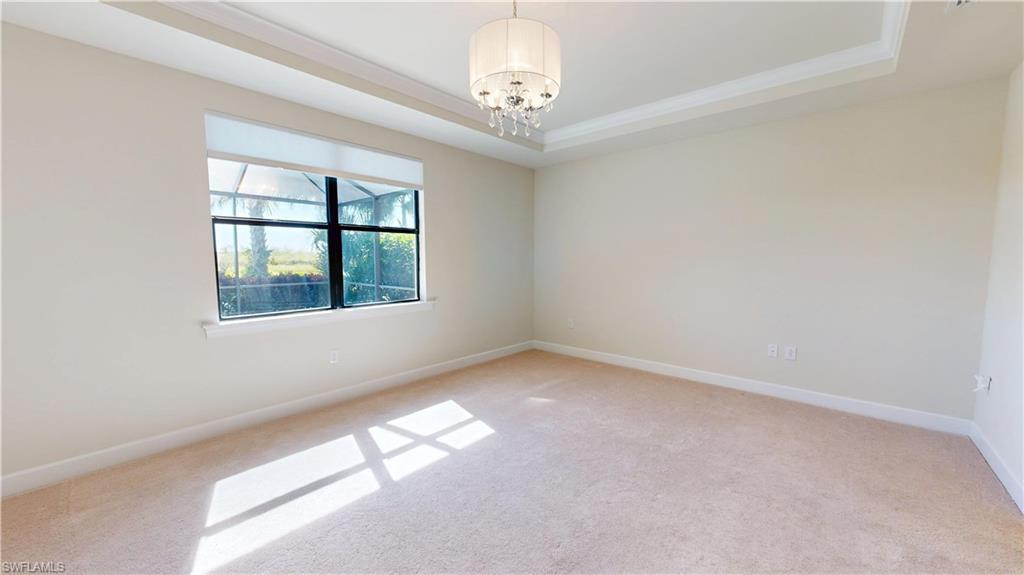 6354 Achievement Avenue Ave Maria, FL 34142 - Photo 28 of 50 an empty room with windows and chandelier fan