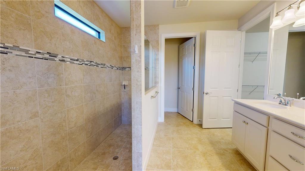 6354 Achievement Avenue Ave Maria, FL 34142 - Photo 31 of 50 a bathroom with a shower sink and mirror