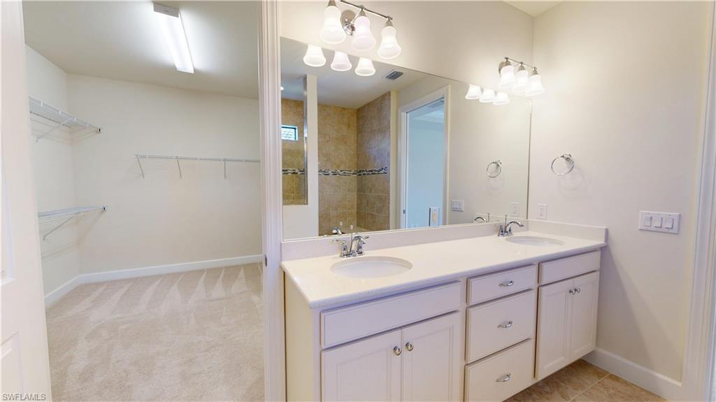 6354 Achievement Avenue Ave Maria, FL 34142 - Photo 34 of 50 a bathroom with a sink double vanity and a mirror