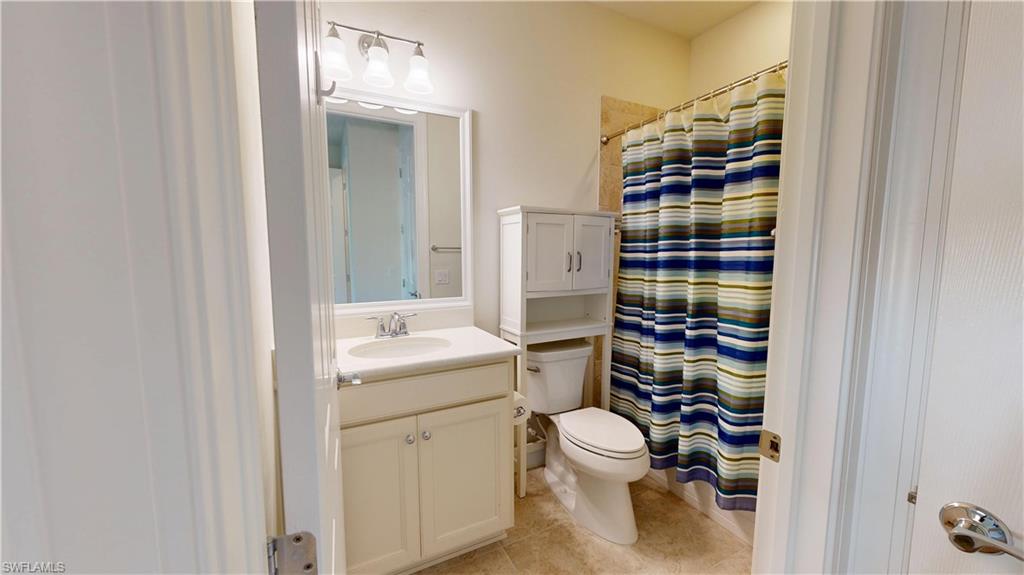 6354 Achievement Avenue Ave Maria, FL 34142 - Photo 38 of 50 a bathroom with a toilet and a shower curtain
