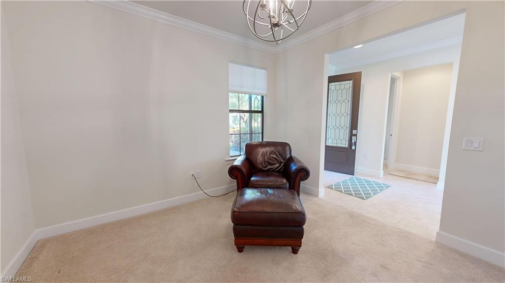 6354 Achievement Avenue Ave Maria, FL 34142 - Photo 41 of 50 a living room with furniture and a chandelier