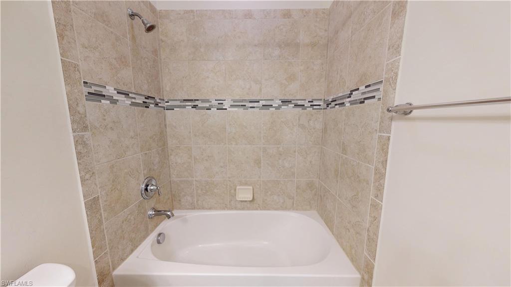 6354 Achievement Avenue Ave Maria, FL 34142 - Photo 46 of 50 a white bath tub sitting next to a shower