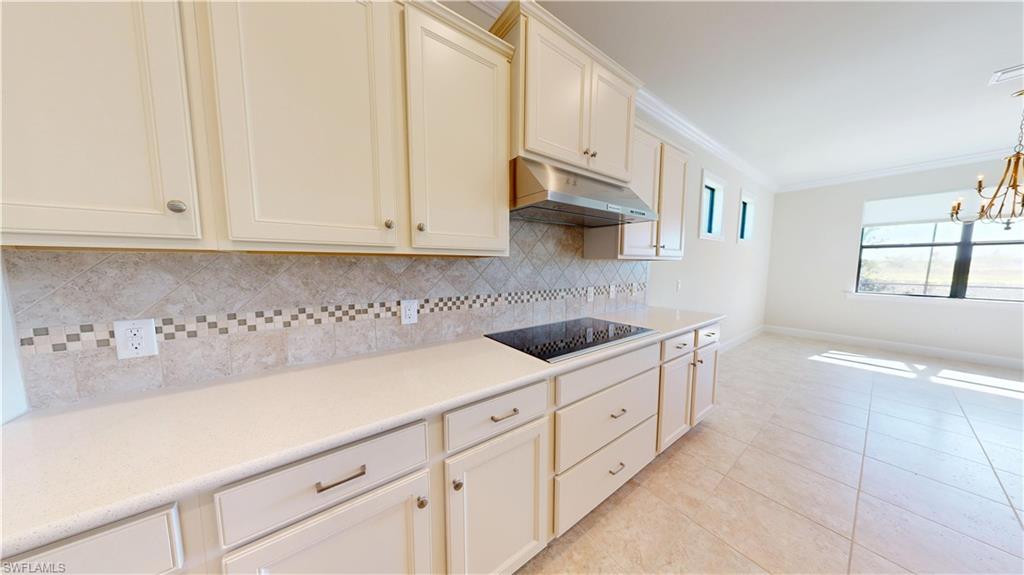 6354 Achievement Avenue Ave Maria, FL 34142 - Photo 8 of 50 a kitchen with granite countertop white cabinets and white appliances