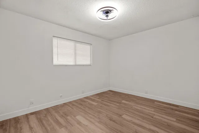 a view of room with wooden floor