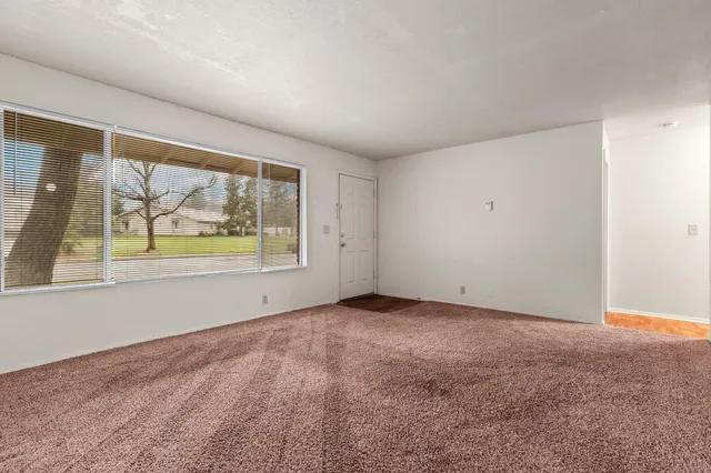 a kitchen with stainless steel appliances granite countertop a refrigerator a sink and a stove