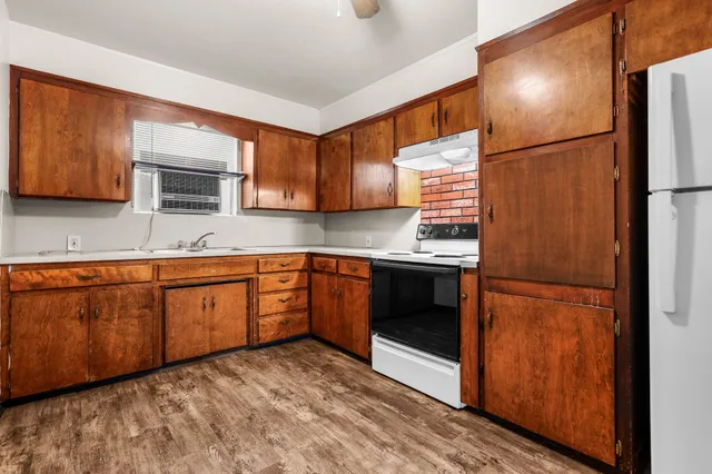 a kitchen with a refrigerator and a sink