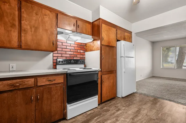 a bedroom with bed and a potted plant