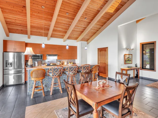 a dining room with furniture and wooden floor