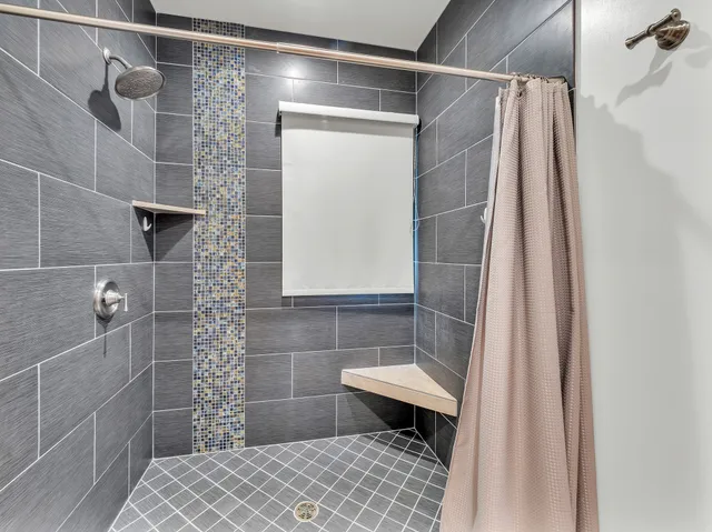 a en suite bathroom with a granite countertop sink and a mirror