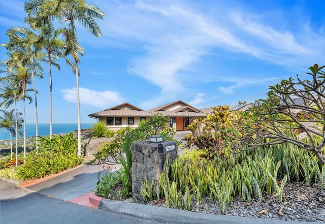 an aerial view of residential house with outdoor space and swimming pool