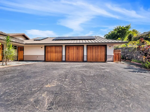front view of a house with a yard and garage