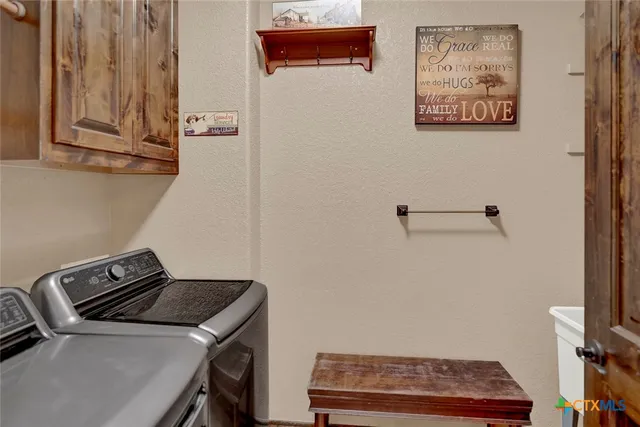 a bathroom with a granite countertop sink a mirror and a shower