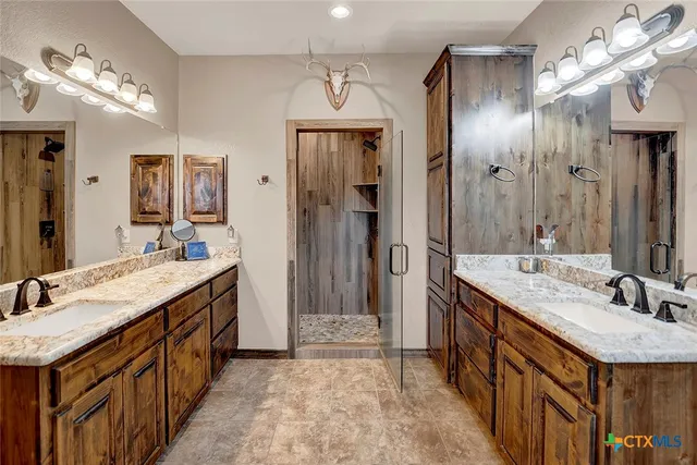 a front view of a house with a garden and trees