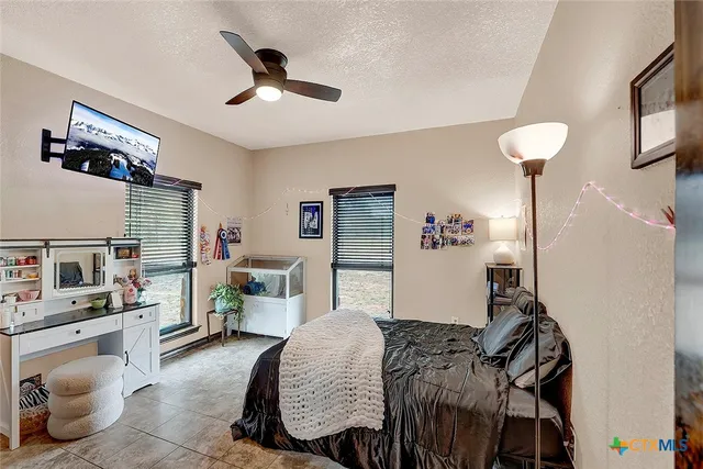 a view of a backyard with table and chairs and potted plants