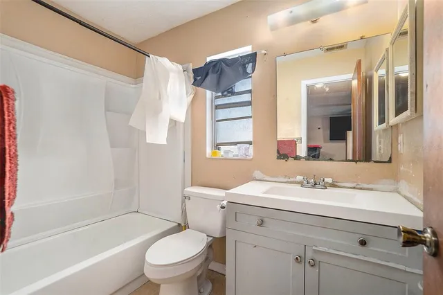 a bathroom with a sink toilet tub and shower