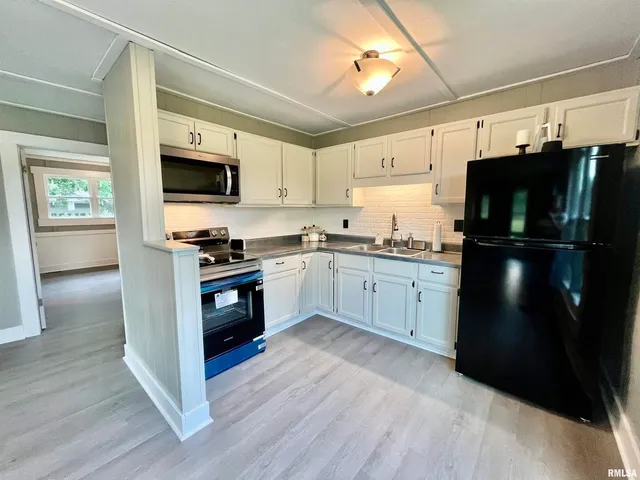 a kitchen with a refrigerator stove and sink