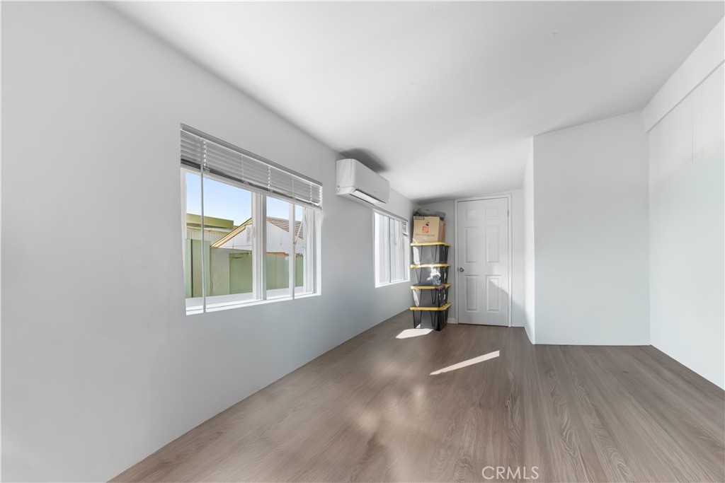 27150 Shadel Road, Unit 122 Menifee, CA 92586 - Photo 11 of 26 an empty room with wooden floor and windows