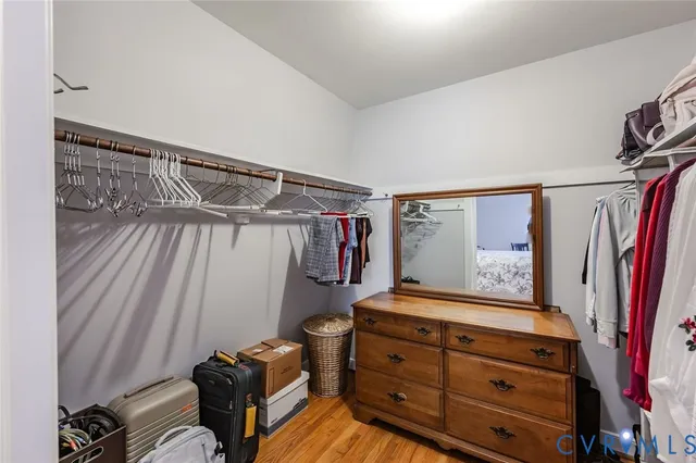 a view of walk in closet with clothes