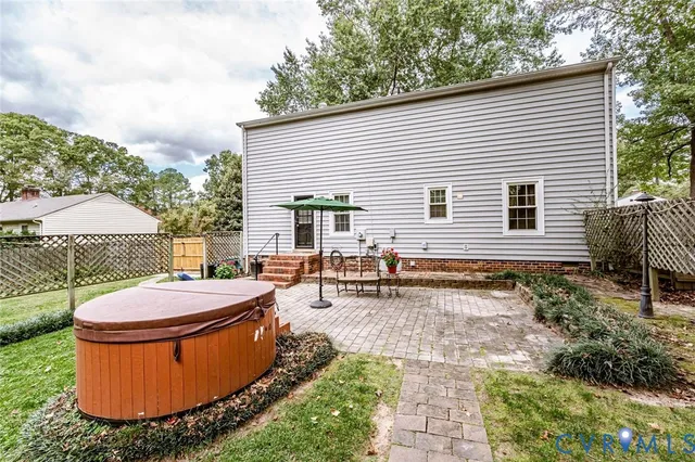 a backyard of a house with table and chairs