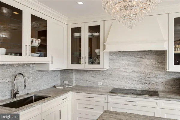 a living room with furniture a dining table and a chandelier