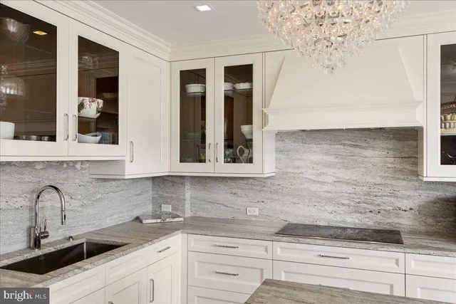 a living room with furniture a dining table and a chandelier