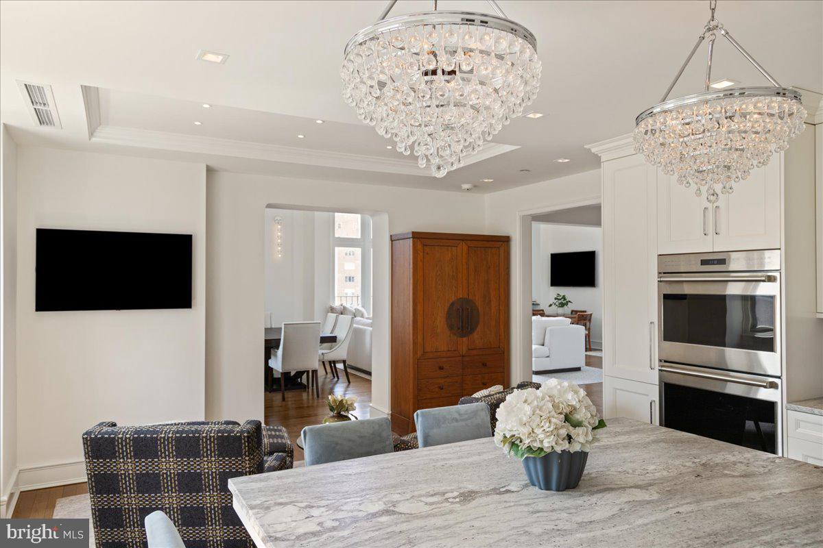 1901 Walnut Street, Unit 19D & 20D Philadelphia, PA 19103 - Photo 14 of 35 a living room with furniture a dining table and a chandelier