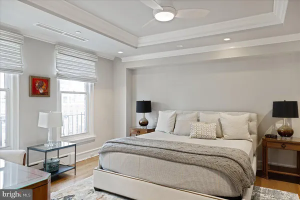 a bedroom with a bed tv and window