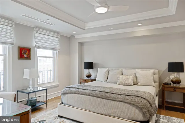 a bedroom with a bed tv and window