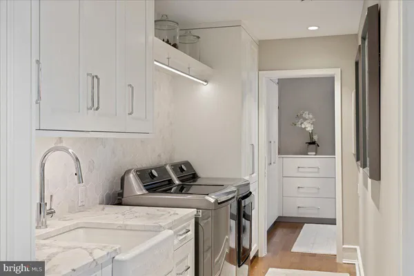 a bathroom with double sink and a mirror