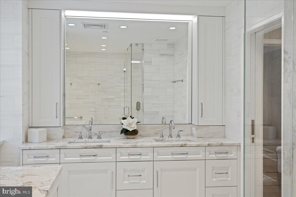 1901 Walnut Street, Unit 19D & 20D Philadelphia, PA 19103 - Photo 20 of 35 a bathroom with double sink and a mirror