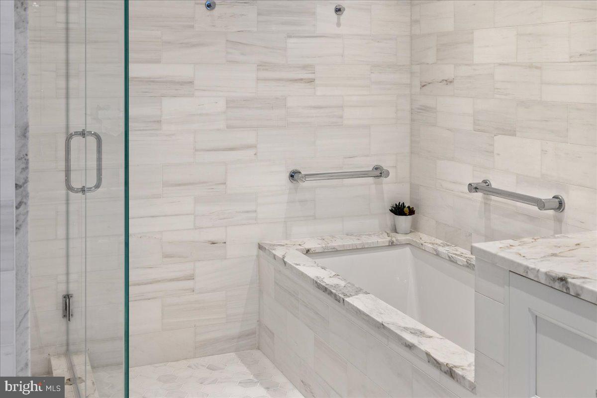 1901 Walnut Street, Unit 19D & 20D Philadelphia, PA 19103 - Photo 21 of 35 a bathroom with a granite countertop sink and shower
