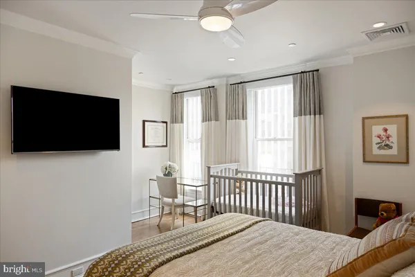 a bedroom with furniture and a flat screen tv