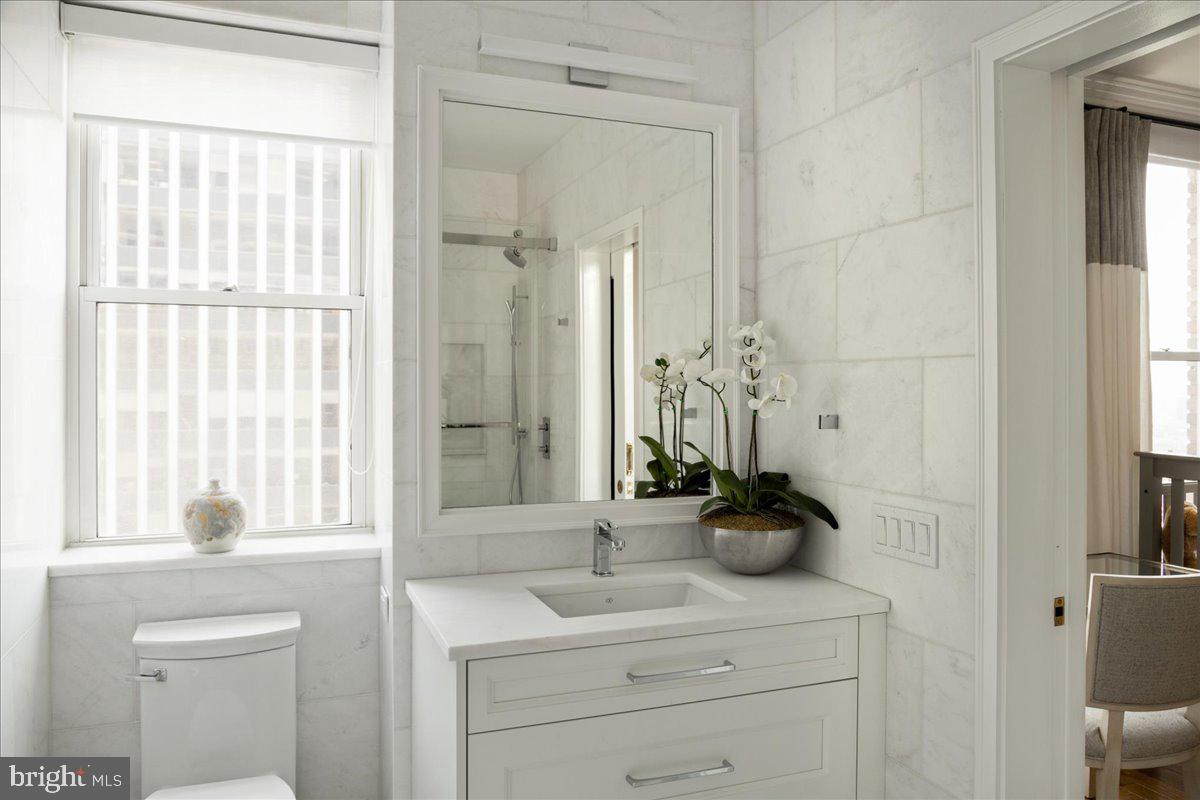 1901 Walnut Street, Unit 19D & 20D Philadelphia, PA 19103 - Photo 28 of 35 a bathroom with a sink a mirror and a shower