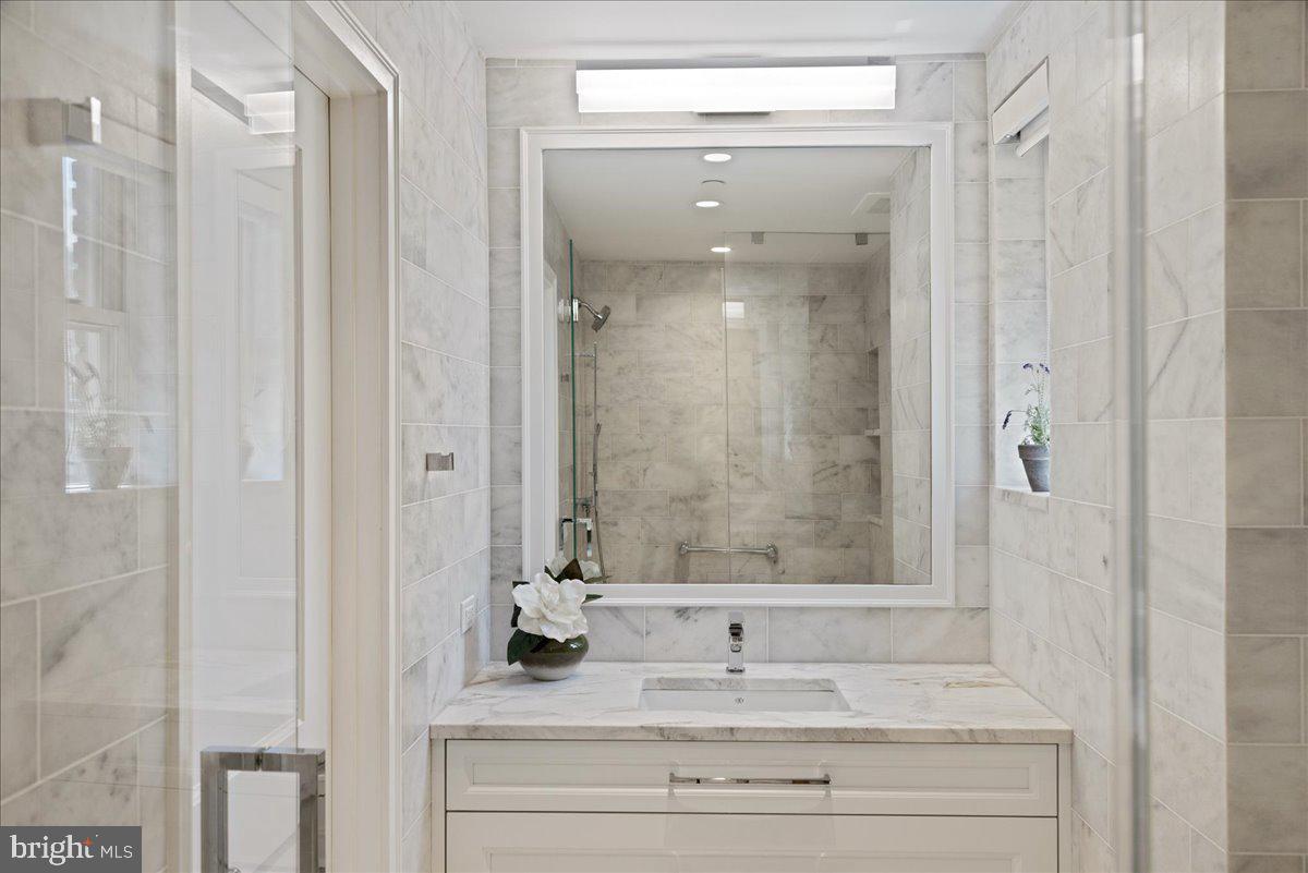 1901 Walnut Street, Unit 19D & 20D Philadelphia, PA 19103 - Photo 33 of 35 a bathroom with a sink and a mirror